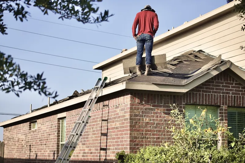 Professional roofer working on a residential roof in Hunters Chase